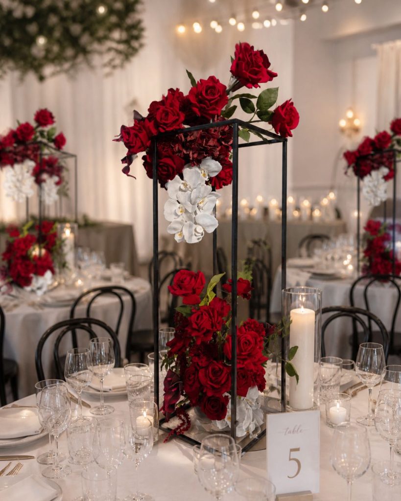 red roses and white orchid floral arrangement centrepiece for wedding