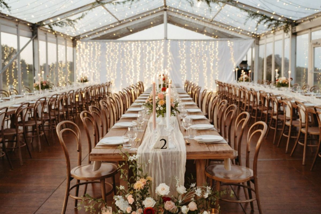 marquee with table settings and fairy lights for a wedding